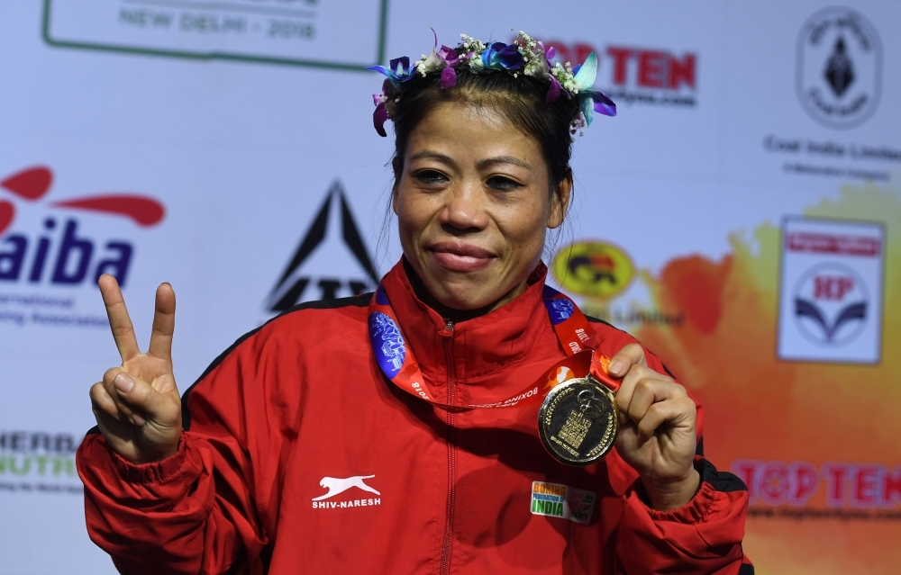 In this file photo Mary Kom of India gestures with her gold medal after winning the 45-48 kg category final fight at the 2018 AIBA Women's World Boxing Championships in New Delhi. — AFP