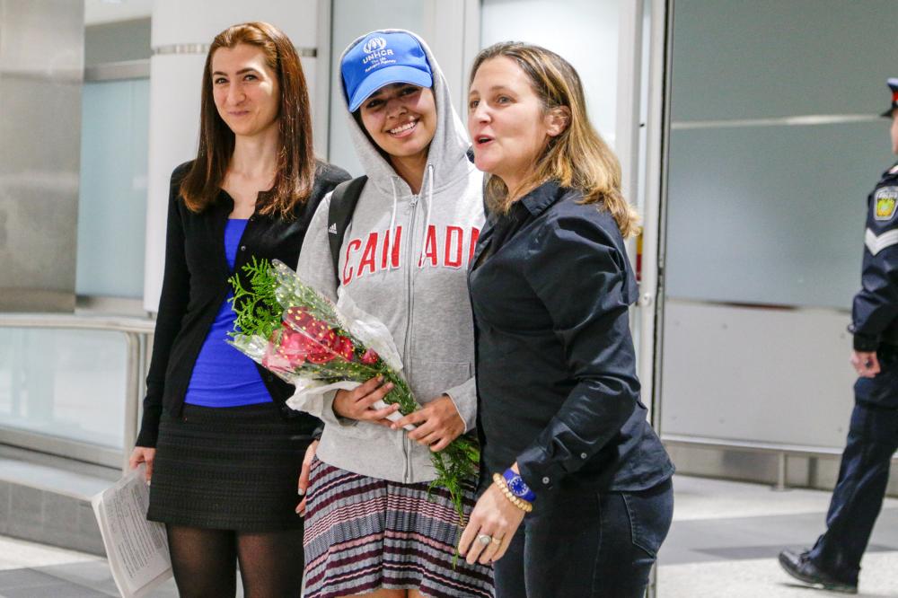 Rahaf Al-Qunun (C) accompanied by Canadian Minister of Foreign Affairs Chrystia Freeland (R) and Saba Abbas, general counsellor of COSTI refugee service agency, arrives at Toronto Pearson International Airport in Toronto, Ontario, Canada on Saturday. — Reuters