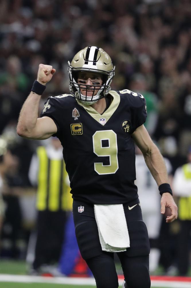 New Orleans Saints’ quarterback Drew Brees celebrates after throwing a touchdown pass against the Philadelphia Eagles during the NFC Divisional playoff football game at Mercedes-Benz Superdome in New Orleans Sunday. — Reuters 