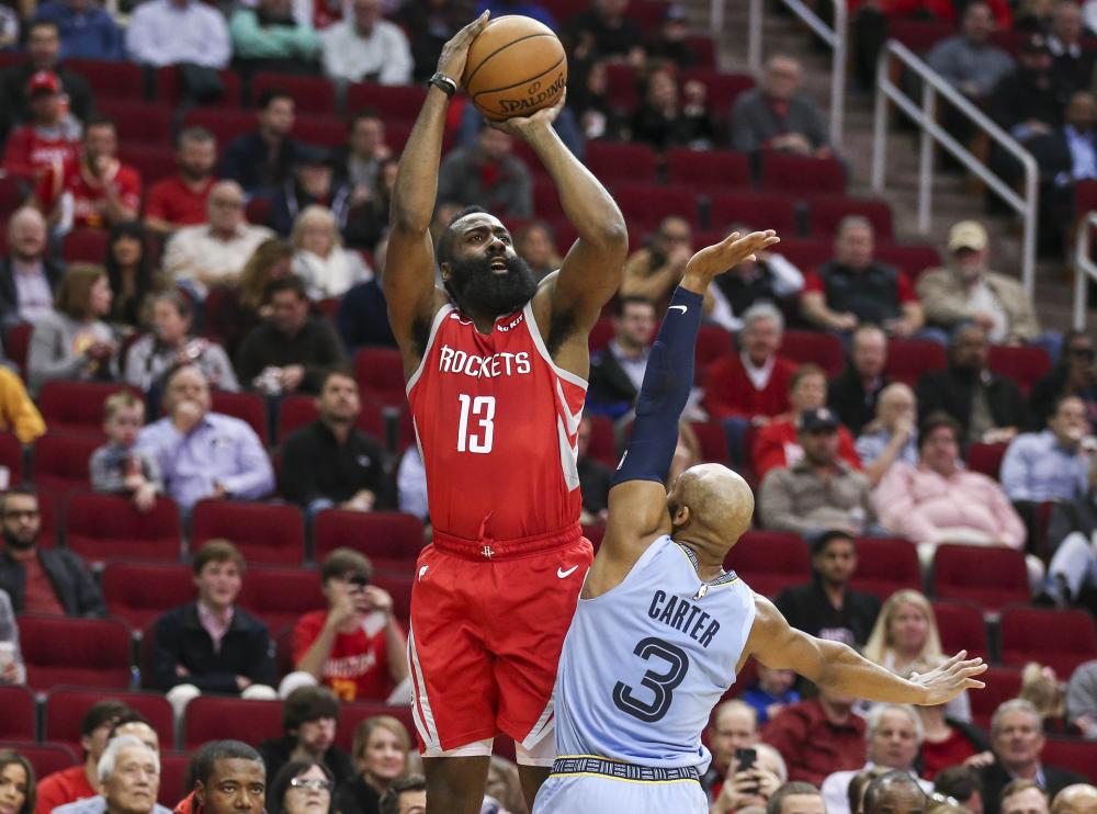 Houston Rockets’ guard James Harden shoots the ball over Memphis Grizzlies’ guard Jevon Carter during their NBA game at Toyota Center in Houston Monday. — Reuters