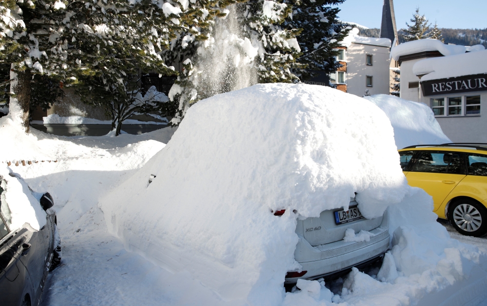 A snow-covered car is seen in Davos, Switzerland, on Tuesday. — Reuters