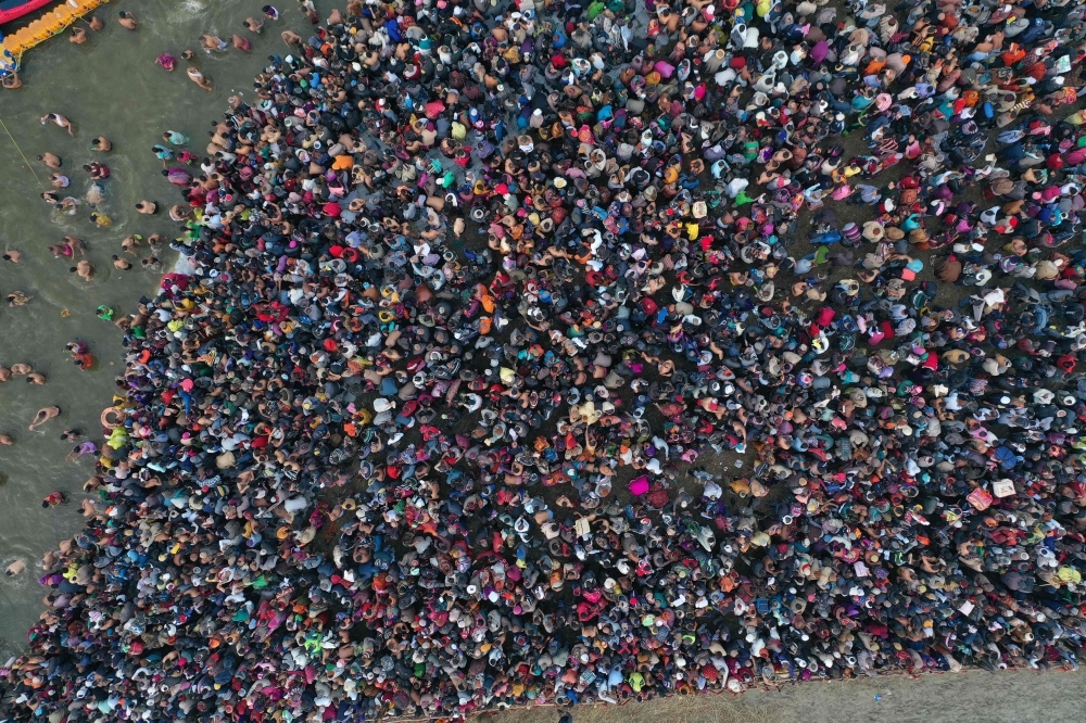 Indian Hindu devotees take a dip at Sangam — the confluence of the Ganges, Yamuna and mythical Saraswati rivers —  at the Kumbh Mela in Allahabad on Tuesday. — AFP