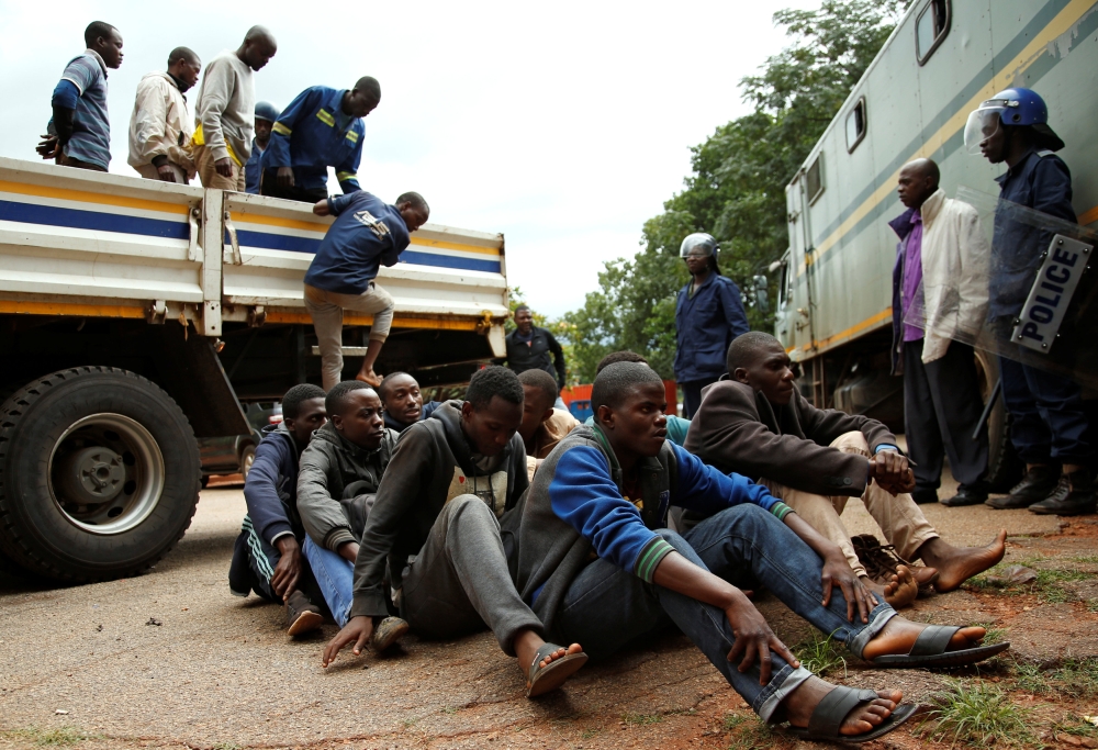 People arrested during protests wait to appear in the Magistrates court in Harare, Zimbabwe, on Wednesday. — Reuters