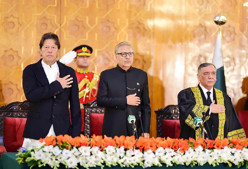 Pakistani Prime Minister Imran Khan, left, Pakistani President Arif Alvi, center, and newly appointed Chief Justice of the Pakistan Supreme Court Asif Saeed Khosa, right, stand for the national anthem during the oath-taking ceremony for new chief justice in Islamabad on Friday. — AFP
