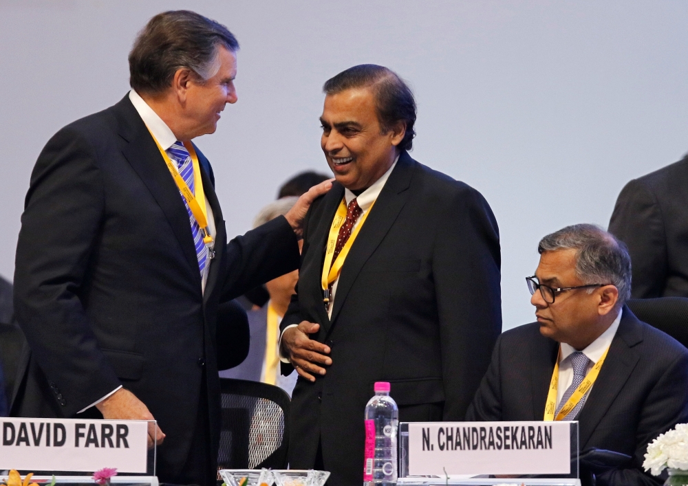 David Farr, CEO of Emerson Electric speaks with Mukesh Ambani, Chairman of Reliance Industries, as Tata Sons Chairman Natarajan Chandrasekaran looks on as they attend the Vibrant Gujarat Global Summit in Gandhinagar, India, on Friday. — Reuters