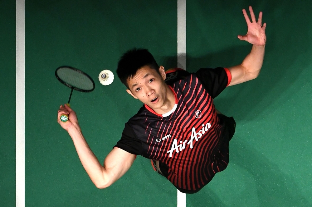 Shi Yuqi of China hits a return against Daren Liew of Malaysia during their men's singles match at the Malaysia Masters badminton tournament in Kuala Lumpur on Friday. —  AFP