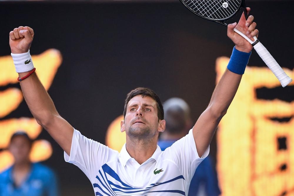 Serbia’s Novak Djokovic celebrates his victory over Canada’s Denis Shapovalov at the Australian Open Tennis Tournament in Melbourne Saturday. — AFP
