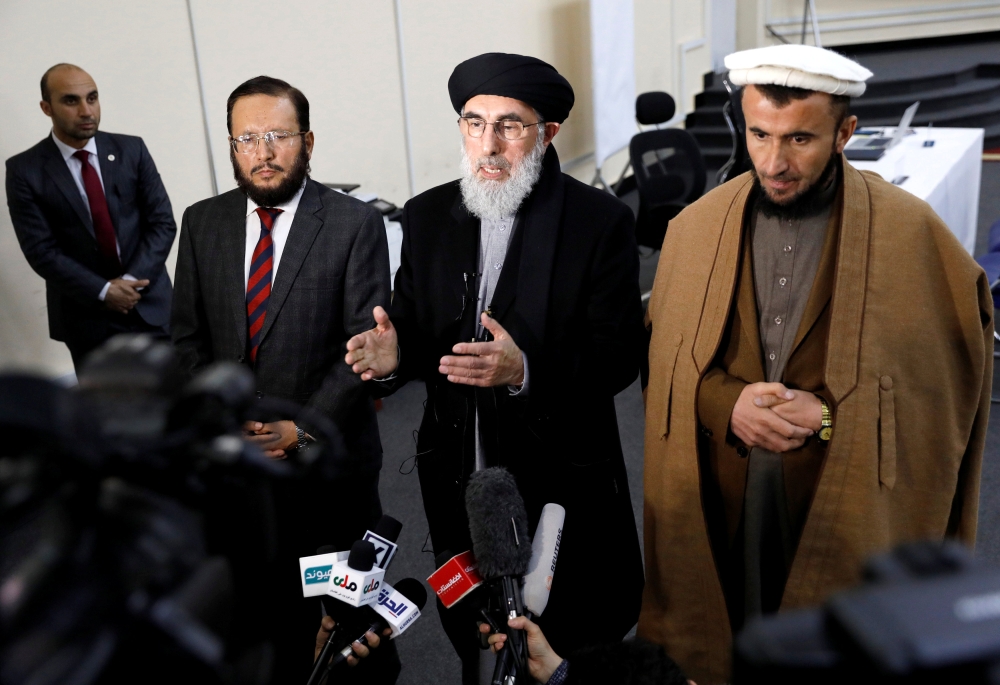 Former Afghan warlord Gulbuddin Hekmatyar (center) alongside his two vice presidential candidates Fazil Hadi Wazeen and Qazi Hafizulrahman Naqi, speaks to the media after arriving to register as a candidate for the presidential election at Afghanistan's Independent Election Commission (IEC) in Kabul. — Reuters