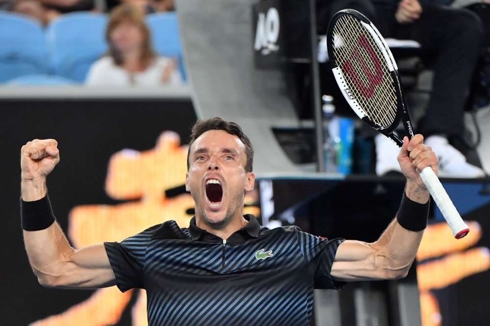 


Spain’s Roberto Bautista Agut celebrates his victory against Croatia’s Marin Cilic at the Australian Open Tennis Tournament in Melbourne Sunday. — AFP