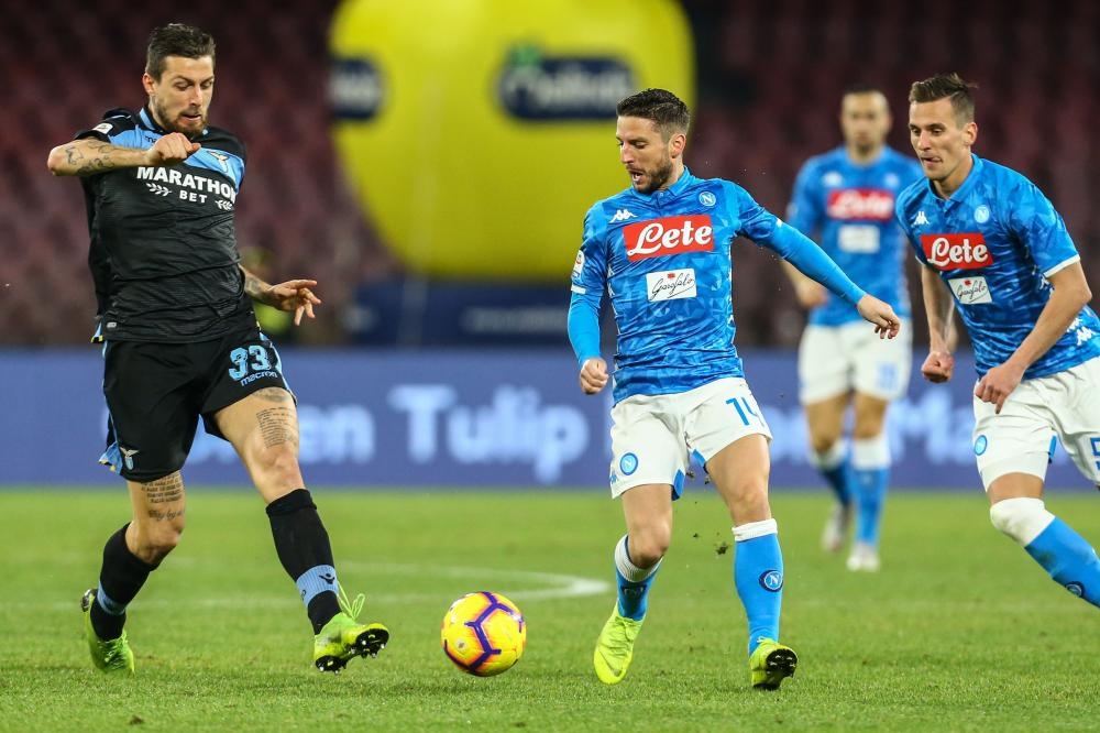 Lazio’s defender Francesco Acerbi (L) and Napoli’s forward Dries Mertens go for the ball during their Italian Serie A football match at the San Paolo Stadium in Naples Sunday. — AFP 