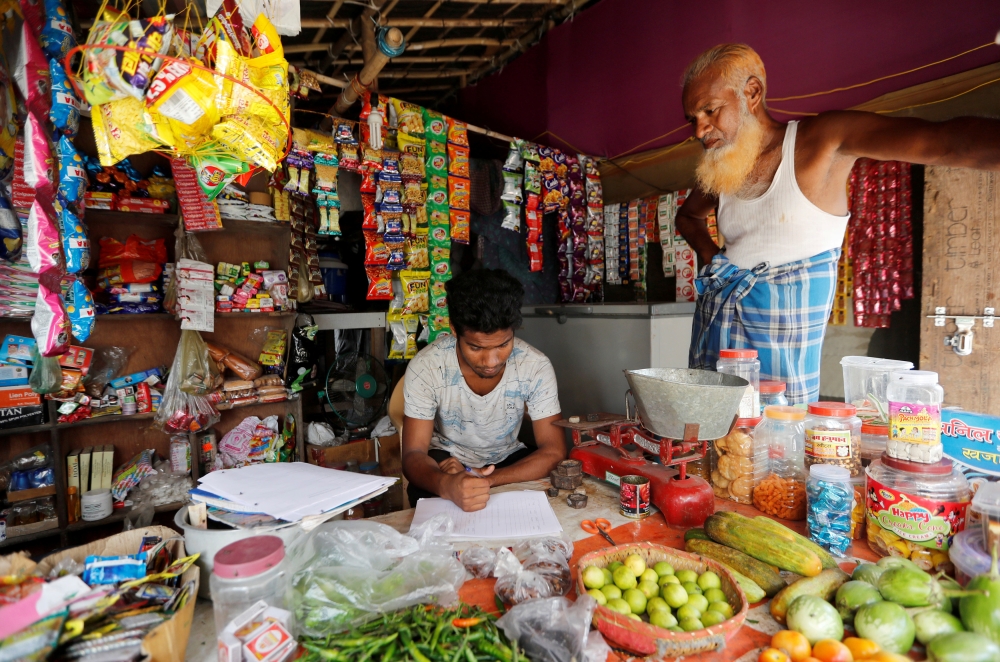 A man from the Rohingya community fills out an identification form, provided by local police, inside his shop at a camp in New Delhi, India, in this Oct. 4, 2018 file photo. — Reuters