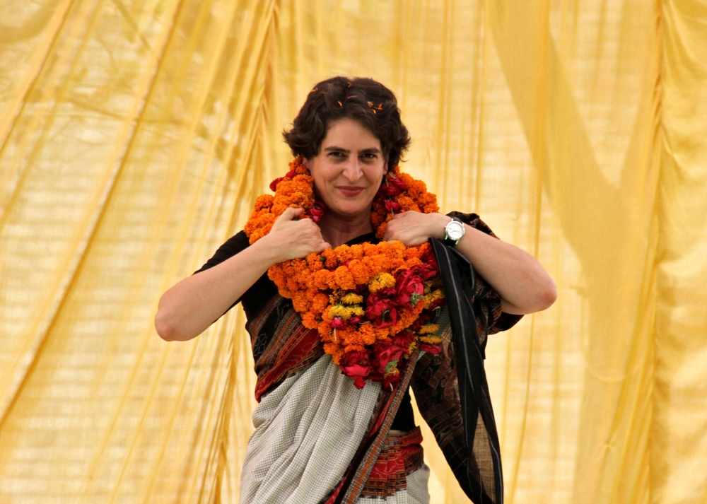 Priyanka Gandhi, daughter of India’s ruling Congress party chief Sonia Gandhi, adjusts her flower garlands as she campaigns for her mother during an election meeting at Rae Bareli in the northern Indian state of Uttar Pradesh in this April 22, 2014 file photo. — Reuters