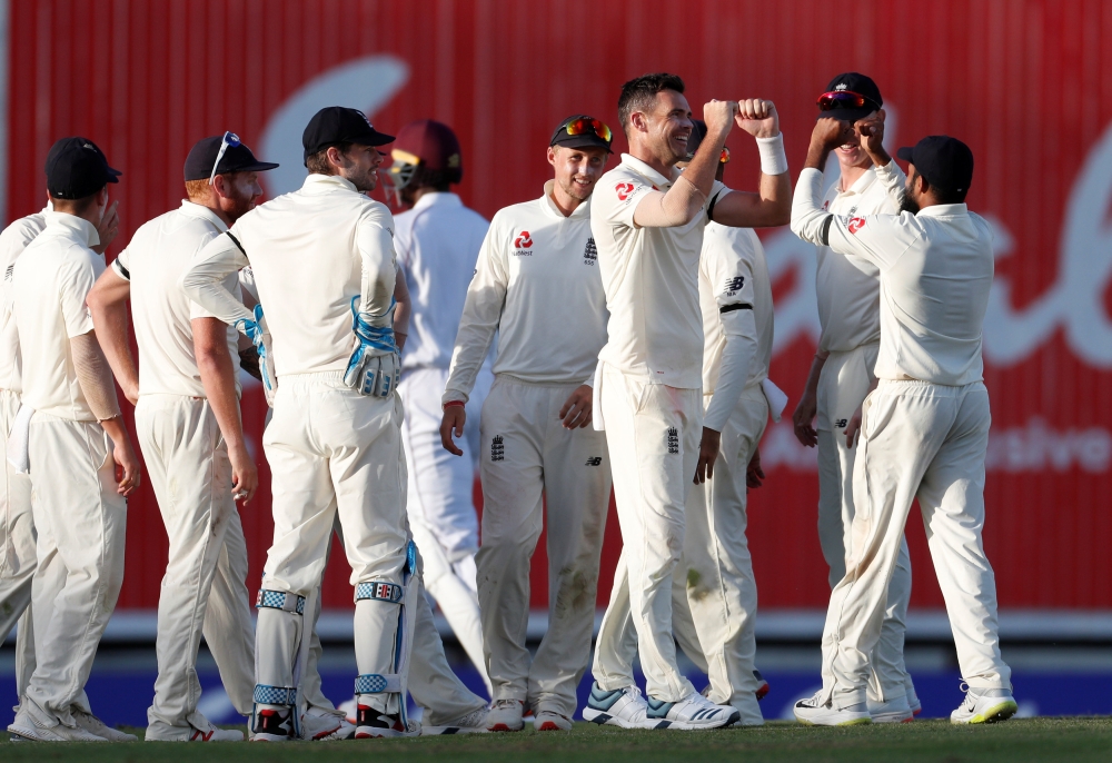 England's James Anderson celebrates with teammates after taking the wicket of West Indies' Jason Holder on the opening day of the First Test at the Kensington Oval, Bridgetown, Barbados, on Wednesday. — Reuters 