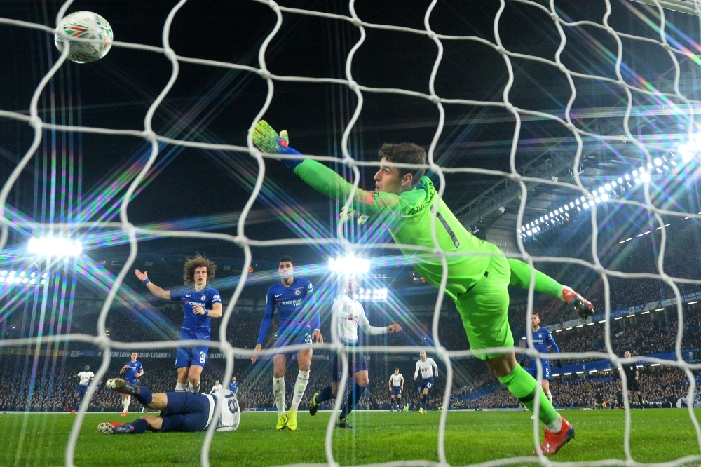 Tottenham Hotspur's Spanish striker Fernando Llorente (L) scores their first goal past Chelsea's Spanish goalkeeper Kepa Arrizabalaga (R) during the English League Cup semifinal second-leg football match between Chelsea and Tottenham Hotspur at Stamford Bridge in London on Thursday.  Chelsea won the tie 4-2 on penalties after the teams drew 2-2 on aggregate after the two leg semifinal. — AFP