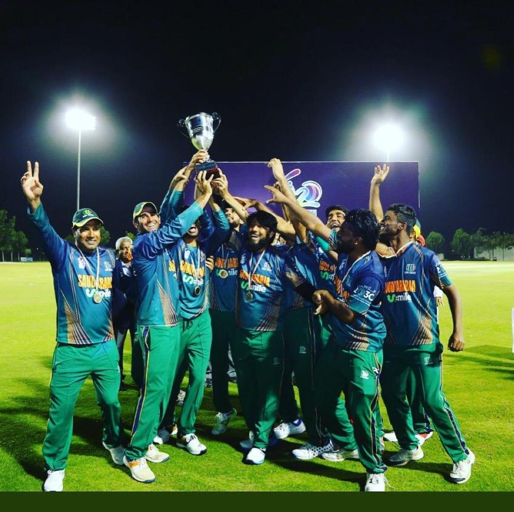 Saudi Arabia team players celebrate with the trophy.