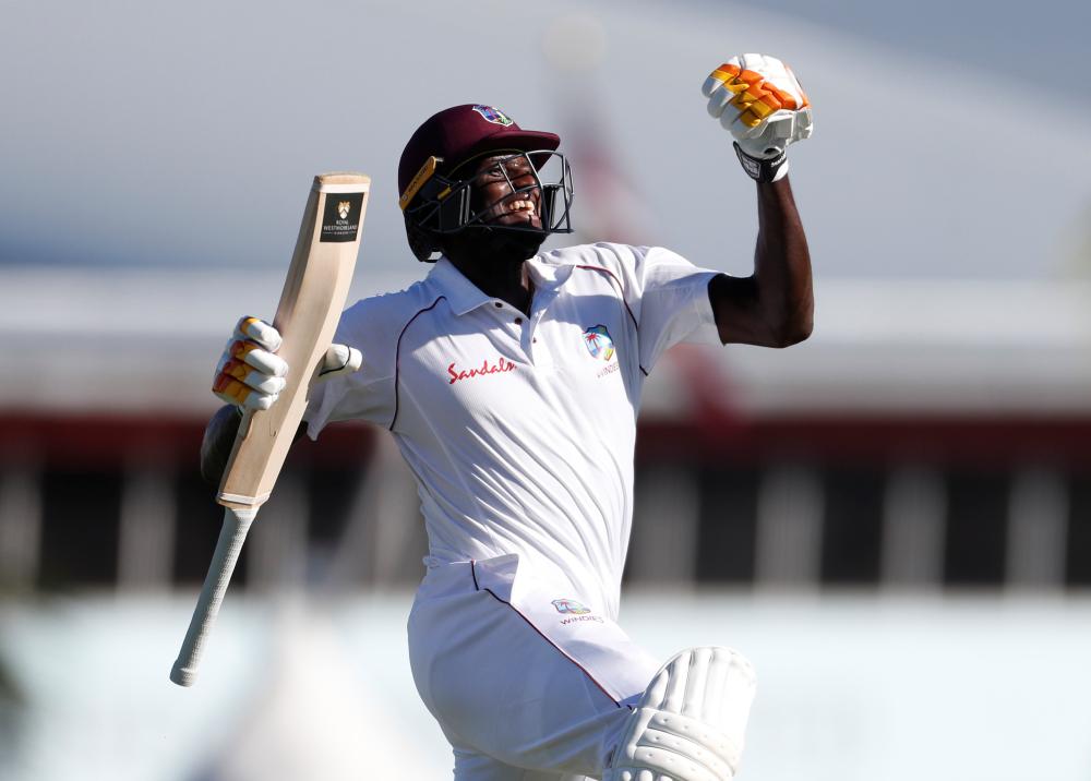 West Indies’ Jason Holder celebrates his double century against England during the third day of their cricket Test match at Kensington Oval in Bridgetown Friday. — Reuters