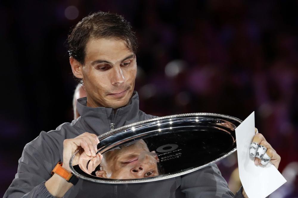 This combination of photos shows Serbia’s Novak Djokovic celebrating with the championship trophy which he won in 2008, 2011, 2012, 2013, 2015, 2016 and 2019 at the Australian Open in Melbourne. — AFP