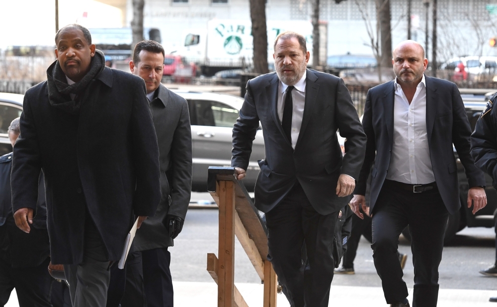 Disgraced Hollywood producer Harvey Weinstein arrives State Supreme Court in Manhattan with his new team of lawyers Jose Baez (2nd L), Ronald Sullivan (L) in New York on Friday. — AFP