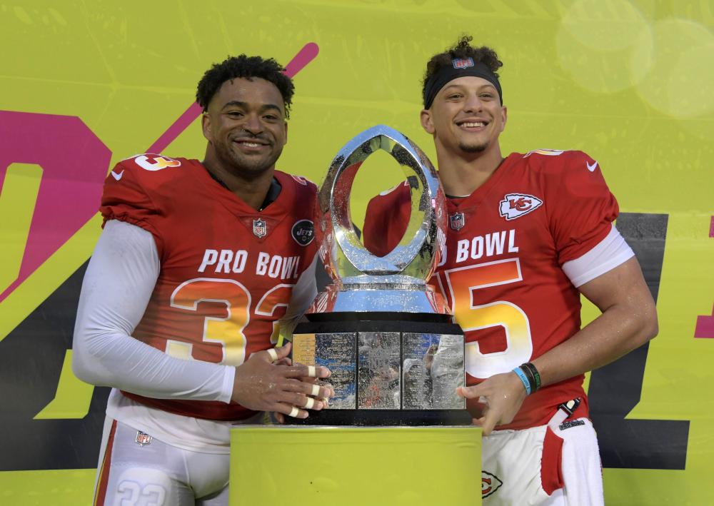 AFC safety Jamal Adams (L) of the New York Jets and quarterback Patrick Mahomes of the Kansas City Chiefs pose with trophy after being selected as most valuable defensive and offensive players of the game in the NFL Pro Bowl football game at Camping World Stadium in Orlando Sunday. — Reuters