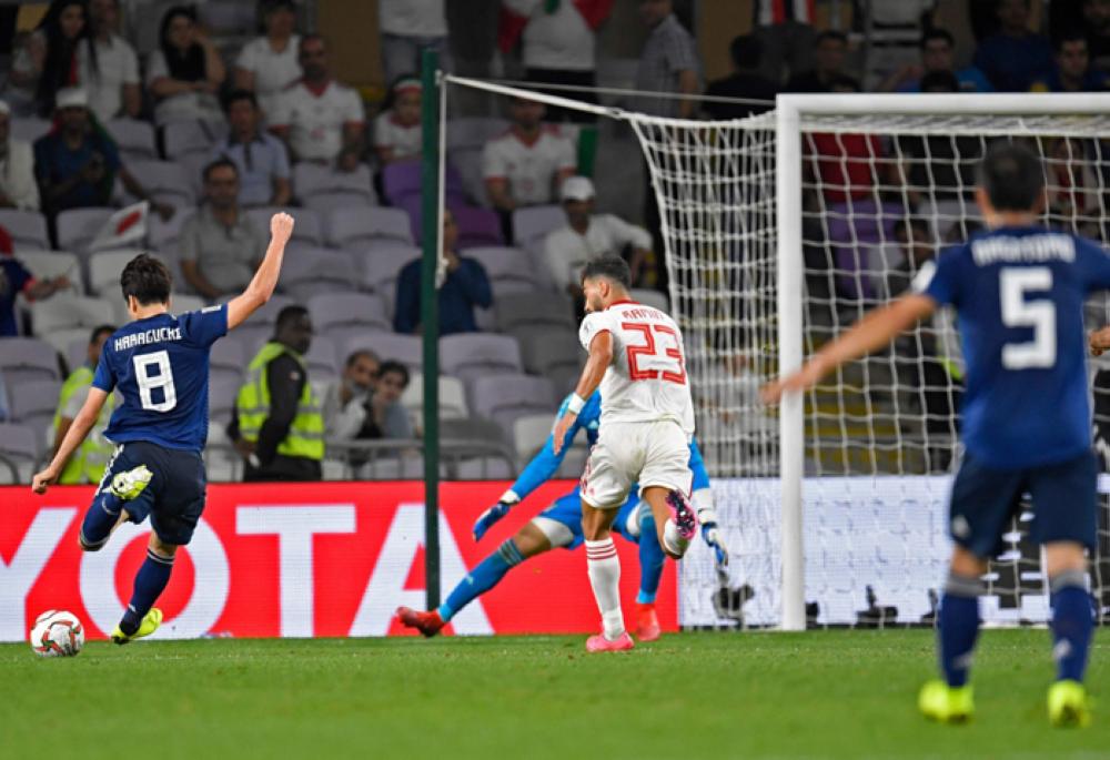 Japan's midfielder Genki Haraguchi (L) shoots to score during the 2019 AFC Asian Cup semi-final football match between Iran and Japan at the Hazza Bin Zayed Stadium in Abu Dhabi on Monday. — AFP 