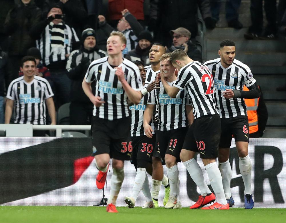 Newcastle United's Matt Ritchie celebrates scoring their second goal with teammates against Manchester City at St James' Park, Newcastle, Tuesday. — Reuters