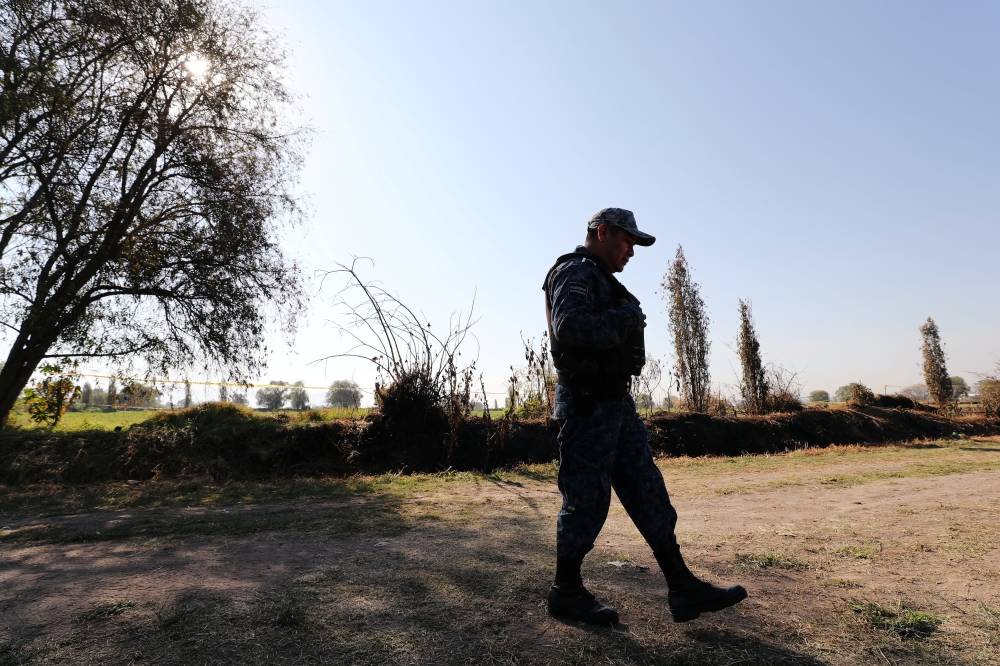 A federal police officer keeps watch at the site where a fuel pipeline, ruptured by suspected oil thieves, exploded in the municipality of Tlahuelilpan, state of Hidalgo, Mexico. — Reuters