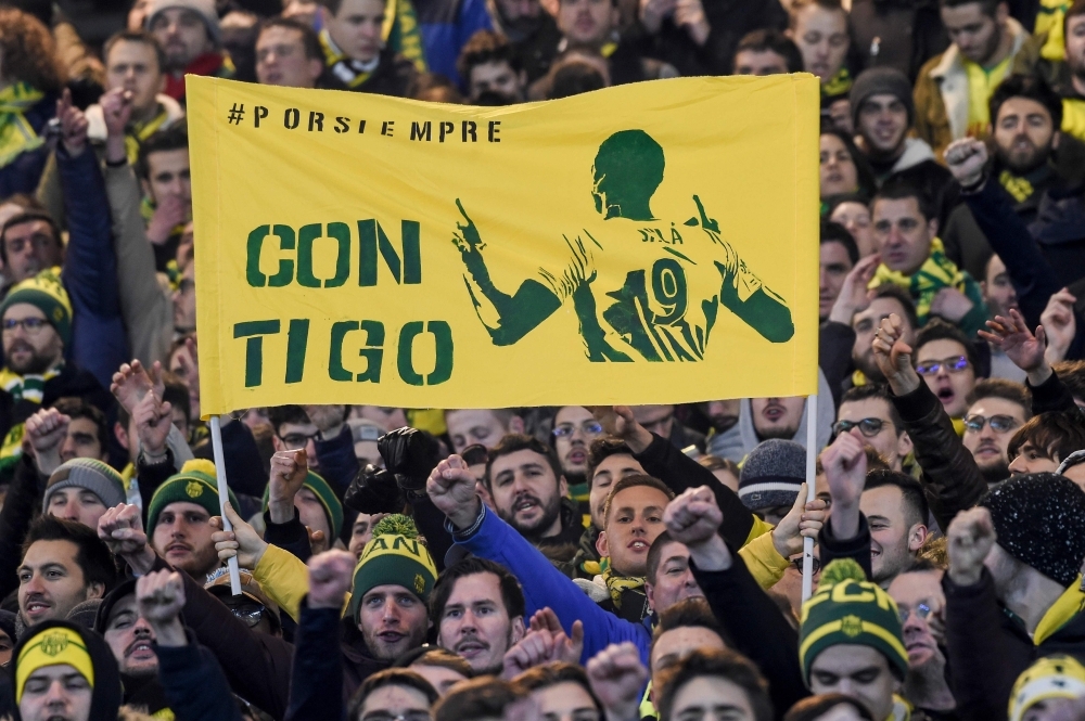 Nantes supporters hold up a banner that reads, 'With you' and showing the image of Nantes' Argentinian forward Emilianio Sala, who is missing following a plane crash, during the French L1 football match between FC Nantes and AS Saint Etienne (ASSE) at the La Beaujoire stadium in Nantes, western France on Wednesday. — AFP