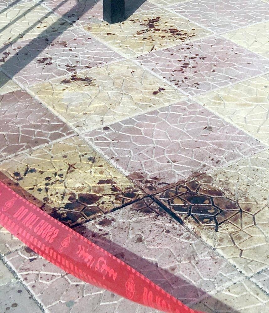


Blood stains at the pavement where the young boy was fatally attacked by an unidentified assailant.