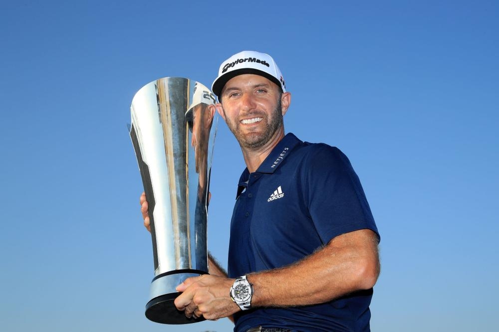 Dustin Johnson holds the Saudi International Trophy.