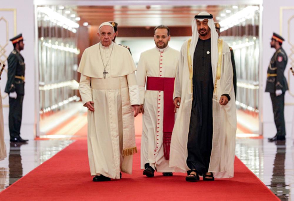 Pope Francis (C-L) is welcomed by Abu Dhabi's Crown Prince Sheikh Mohammed bin Zayed Al-Nahyan (C-R) upon his arrival at Abu Dhabi International Airport in the UAE capital on Sunday. —AFP