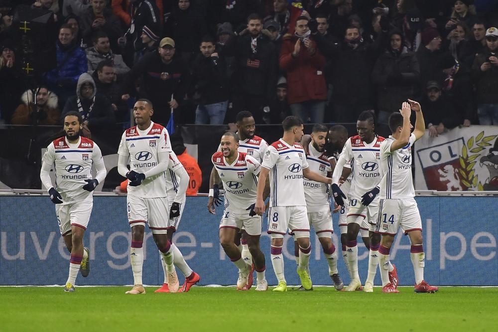 Lyon’s forward Nabil Fekir (C right) jubilates with teammates after scoring a goal during the French L1 football match against Paris-Saint Germain at Groupama Stadium in Decines-Charpieu, near Lyon, Sunday. — AFP