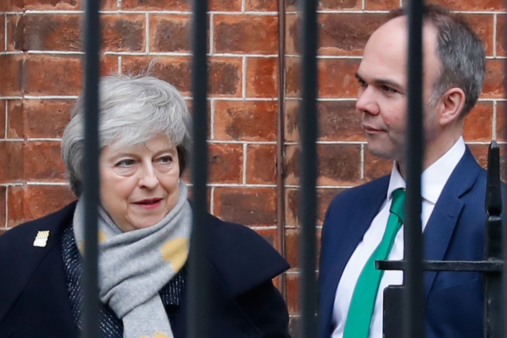 Britain's Prime Minister Theresa May (L) leaves 10 Downing Street in London on Tuesday with Number 10 Chief of Staff Gavin Barwell (R). — AFP