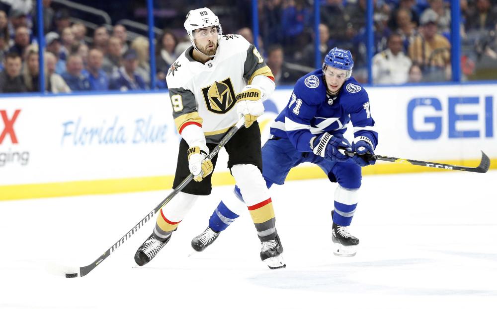 Vegas Golden Knights’ right wing Alex Tuch (L) passes the puck as Tampa Bay Lightning’s center Anthony Cirelli defends during their NHL game at Amalie Arena in Pampa Tuesday. — Reuters