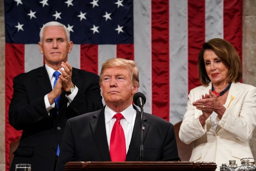 US President Donald Trump delivers the State of the Union address, alongside Vice President Mike Pence and Speaker of the House Nancy Pelosi, at the US Capitol in Washington, DC, on Tuesday. — AFP