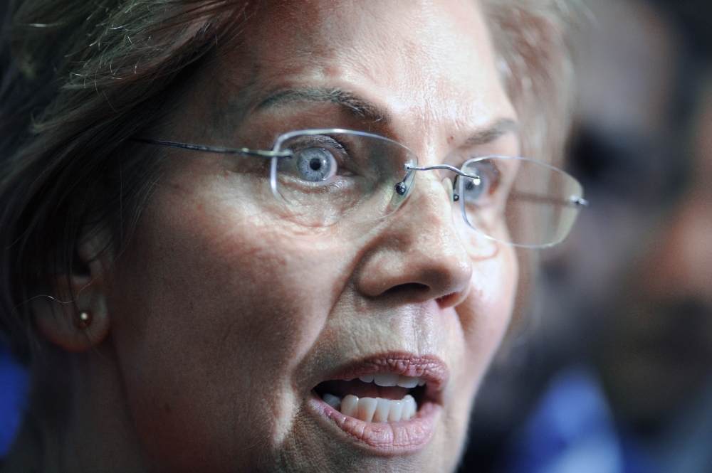 In this file photo Senator Elizabeth Warren (D-MA) speaks with press during an “Organizing Event” as part of her exploratory presidential committee at Manchester Community College in Manchester, New Hampshire. Warren is one of the senators calling for Senate banking committee to investigate allegations of money laundering involving Deutsche Bank. — AFP