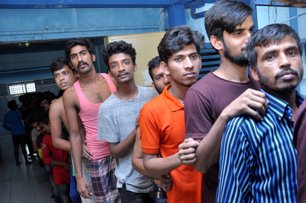 Bangladesh men stand as they arrive at immigration detention center in Medan, North Sumatra, Indonesia, on Wednesday. — Reuters