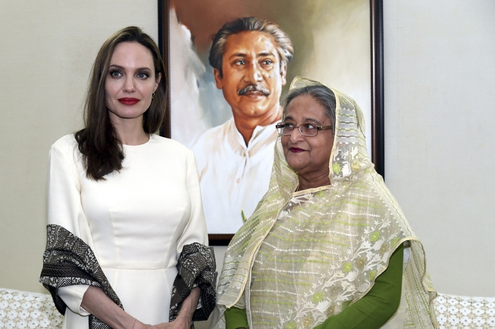 US actress, filmmaker and humanitarian Angelina Jolie (L), a special envoy for the United Nations High Commissioner for Refugees (UNHCR), looks on as she meets Bangladesh Prime Minister Sheikh Hasina following her visit in Dhaka on Wednesday. Angelina Jolie said that Myanmar must 