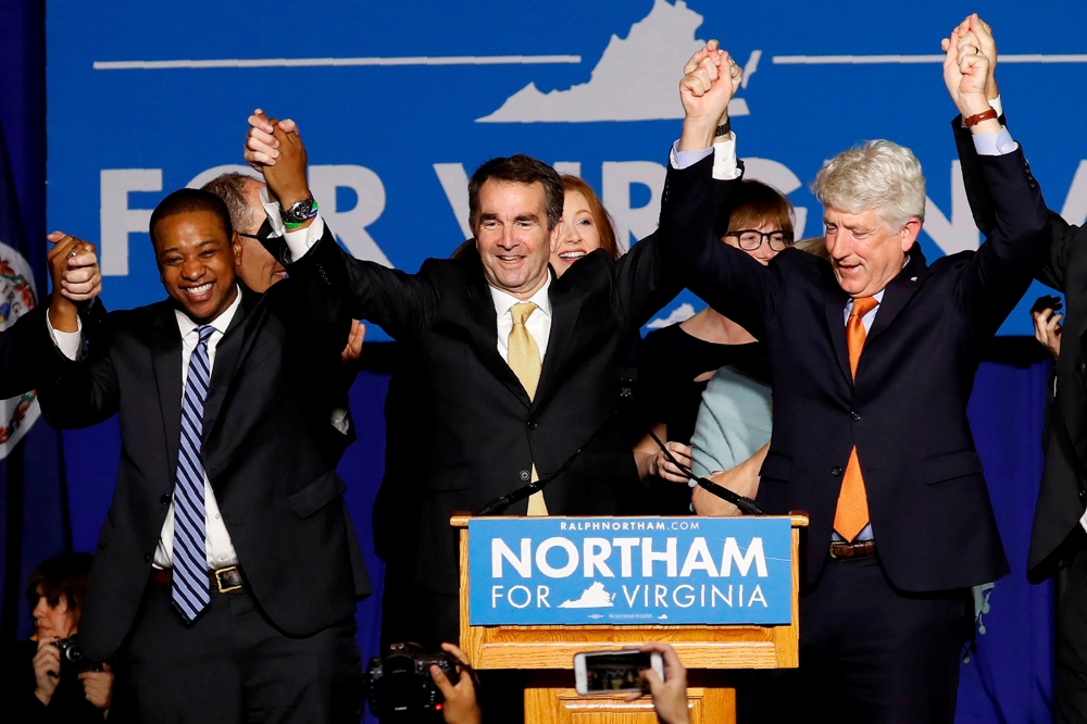 Virginia Governor Elect Ralph Northam (C) celebrates with Lt. Governor Elect Justin Fairfax and Attorney General Mark Herring at his election night rally on the campus of George Mason University in Fairfax, Virginia, in this file photo. — Reuters