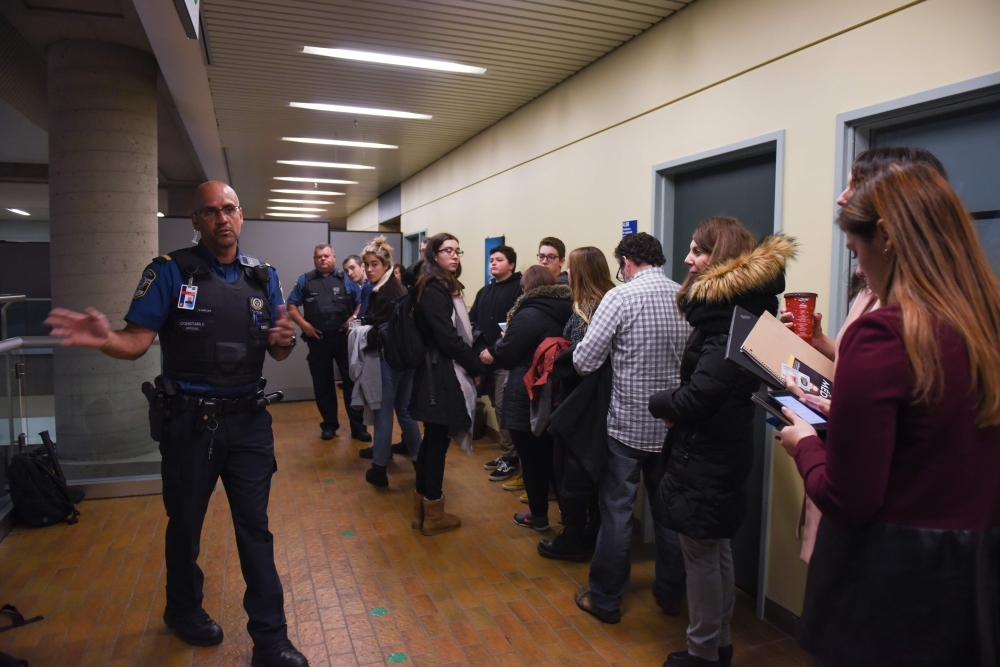 Journalists wait to pass security in the Quebec City Courthouse on Friday.  Canadian Alexandre Bissonnette was given a life sentence for killing six worshippers at the Quebec City mosque in January 2017 in the worst ever attack on Muslims in the West. — AFP