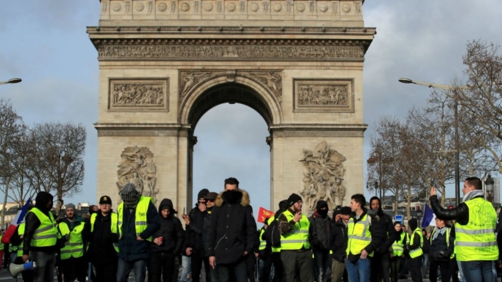 Protesters wearing yellow vests take part in a demonstration in Paris, Saturday. — Reuters 