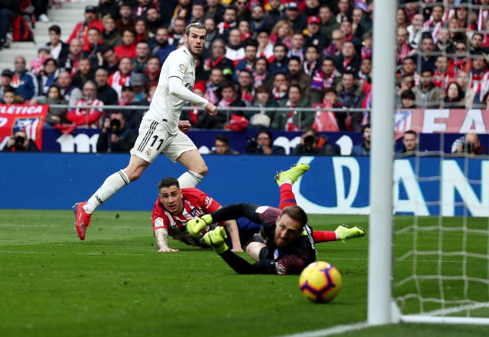 Real Madrid's Gareth Bale scores their third goal against Atletico Madrid during their Spanish football league match at Wanda Metropolitano in Madrid Saturday. — Reuters