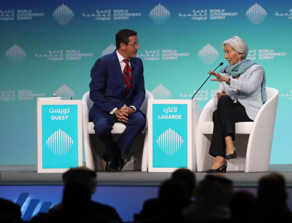 Christine Lagarde (R), Managing Director and Chairwoman of the International Monetary Fund, speaks to journalist Richard Quest. — AFP