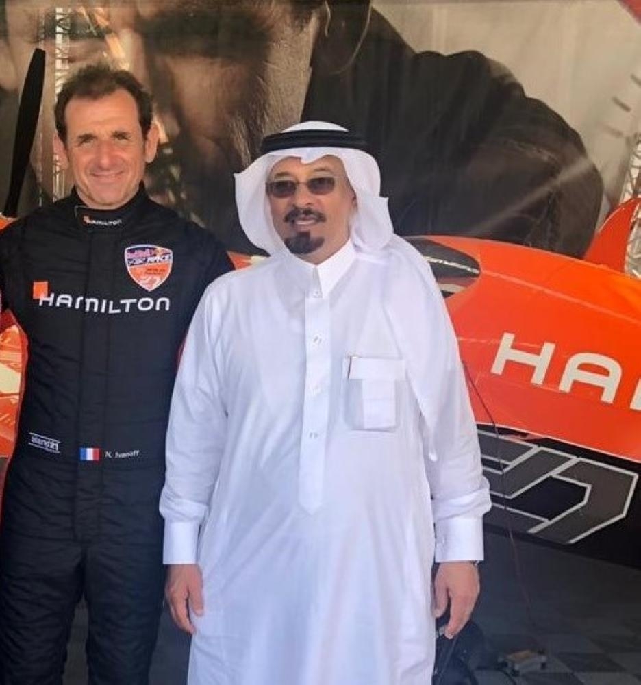 Abdullatif Mohammed Al-Ali Al-Abdullatif, CEO of Al-Ghazali Trade, which is the agent for Hamilton watches in Saudi Arabia, poses in front of one of the planes with Hamilton brand name emblazoned on the fuselage
