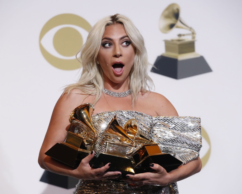 Lady Gaga poses backstage with her awards for Best Song Written for Visual Media and Best Pop Duo/Group Performance for 
