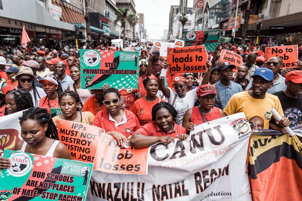Members of the Congress of South African Trade Unions (COSATU) hold placards and shout slogans during a demonstration in Durban, South Africa, on Wednesday. — AFP