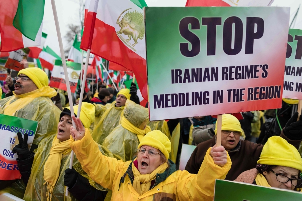 People demonstrate with banners and placards during a rally in Warsaw on Wednesday in supporters of the National Council of Resistance of Iran, demanding tougher policy on Iran and its violation of human rights. — AFP