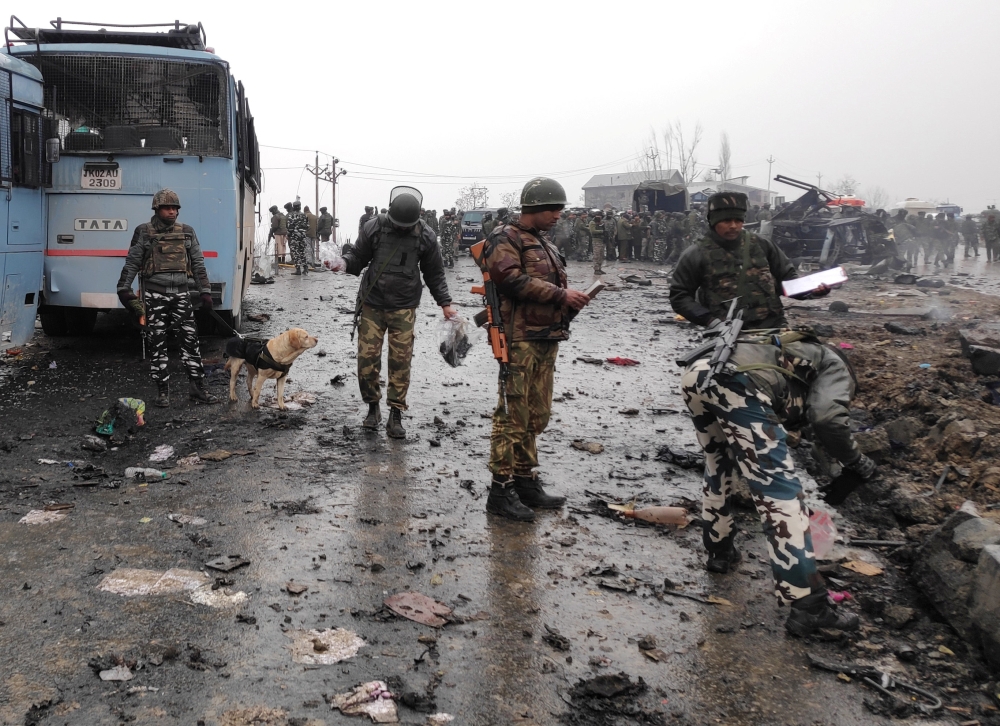 Indian soldiers examine the debris after an explosion in Lethpora in south Kashmir’s Pulwama district on Thursday. — Reuters