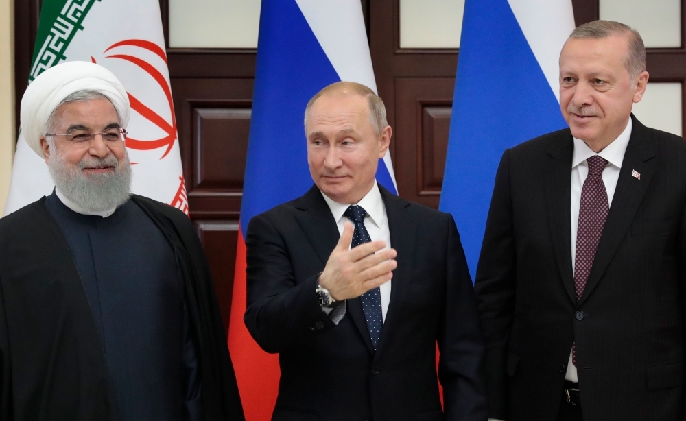 Russian President Vladimir Putin, center, Turkish President Recep Tayyip Erdogan, right, and Iranian President Hassan Rouhani pose prior to a trilateral meeting on Syria in the Black Sea resort of Sochi on Thursday. — AFP