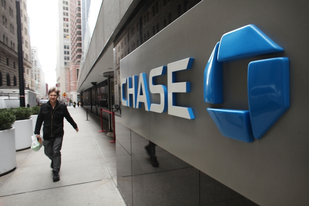 In this file photo, a man walks past a Chase sign at the company's Manhattan headquarter's in New York City. JPMorgan Chase on Thursday unveiled a prototype for a digital coin system using blockchain, a first among major banks in the fast-changing cryptocurrency world. — AFP