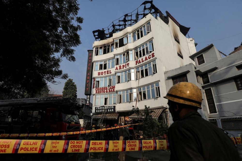 A fireman stands outside the hotel where a fire broke out in New Delhi, India, in this Feb. 12, 2019 file photo. — Reuters